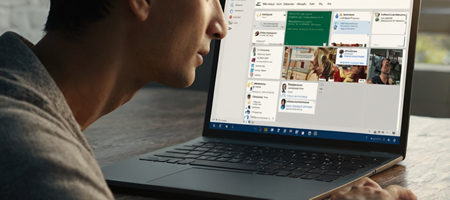 A user managing a Microsoft Lists interface on a laptop, with a structured task-tracking system visible.