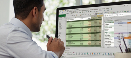 A business professional working in Excel, with a Power Query editor open and a PivotTable summarizing data.
