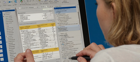 A professional working on a Microsoft Word document, adjusting formatting and using styles to create a polished report.
